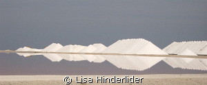 Reflections. Salt piles behind the drying ponds. Bonaire by Lisa Hinderlider 